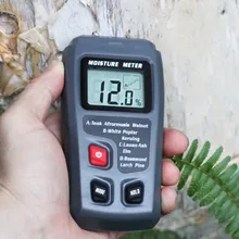 Hand held moisture meter showing reading
